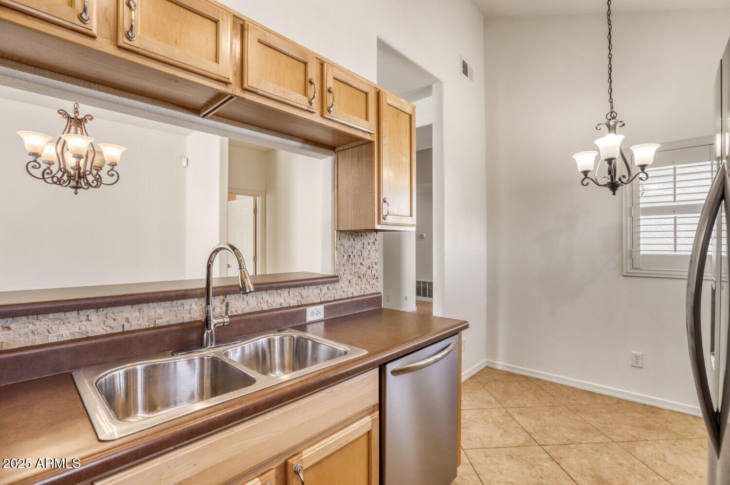 7101 West Beardsley Road, Unit 1403 Glendale, AZ 85308 - Photo 16 of 40 a kitchen with a sink and chandelier
