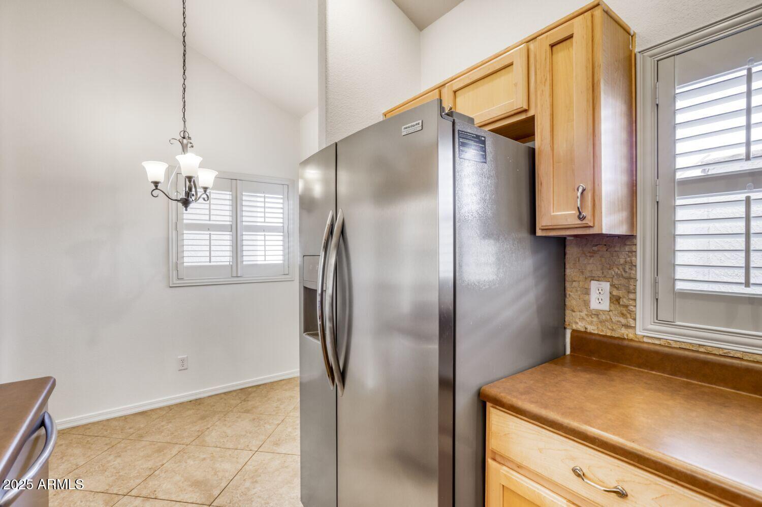7101 West Beardsley Road, Unit 1403 Glendale, AZ 85308 - Photo 17 of 40 a kitchen with stainless steel appliances granite countertop a refrigerator and a window