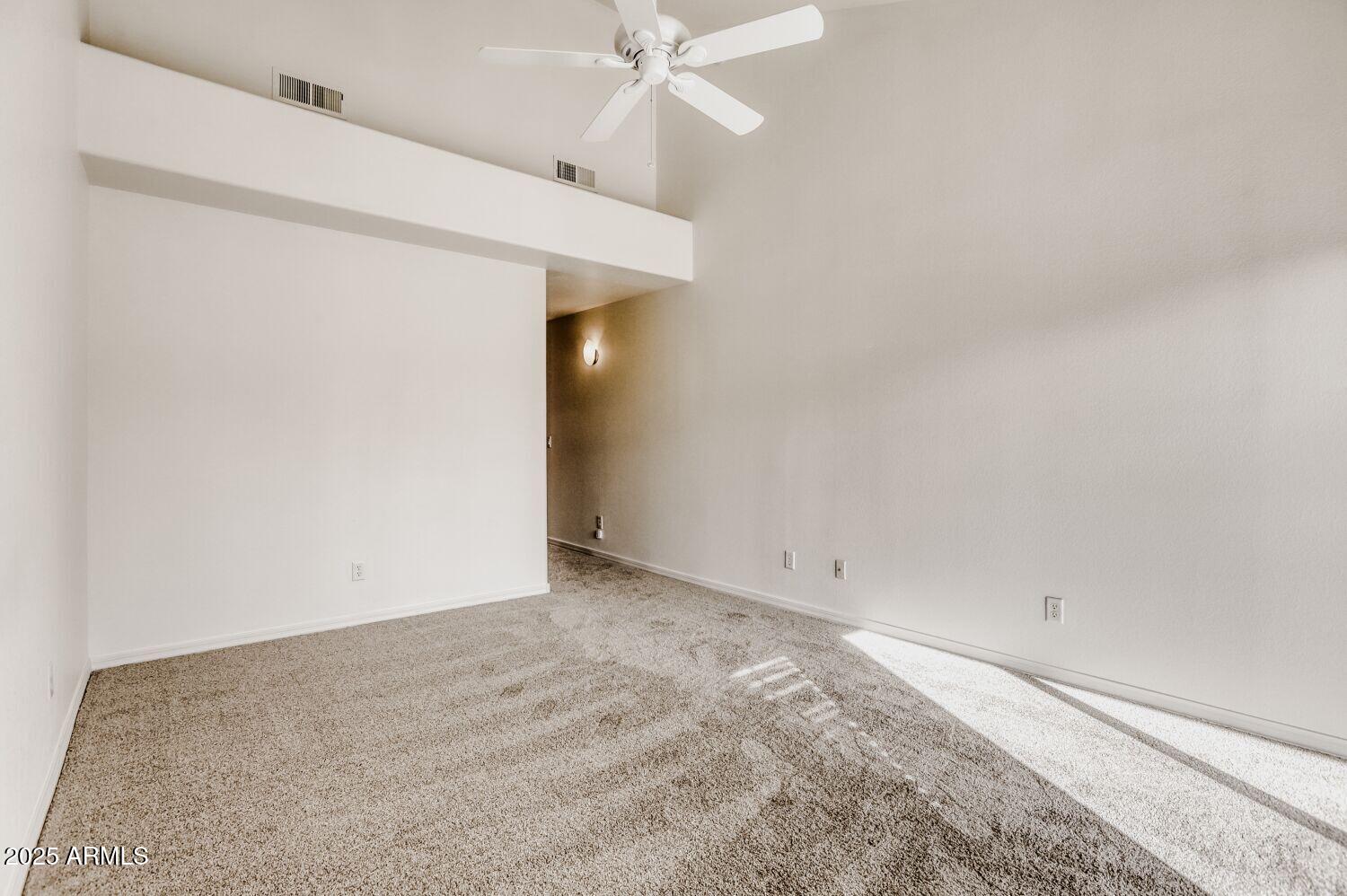 7101 West Beardsley Road, Unit 1403 Glendale, AZ 85308 - Photo 22 of 40 an empty room with a ceiling fan and closet