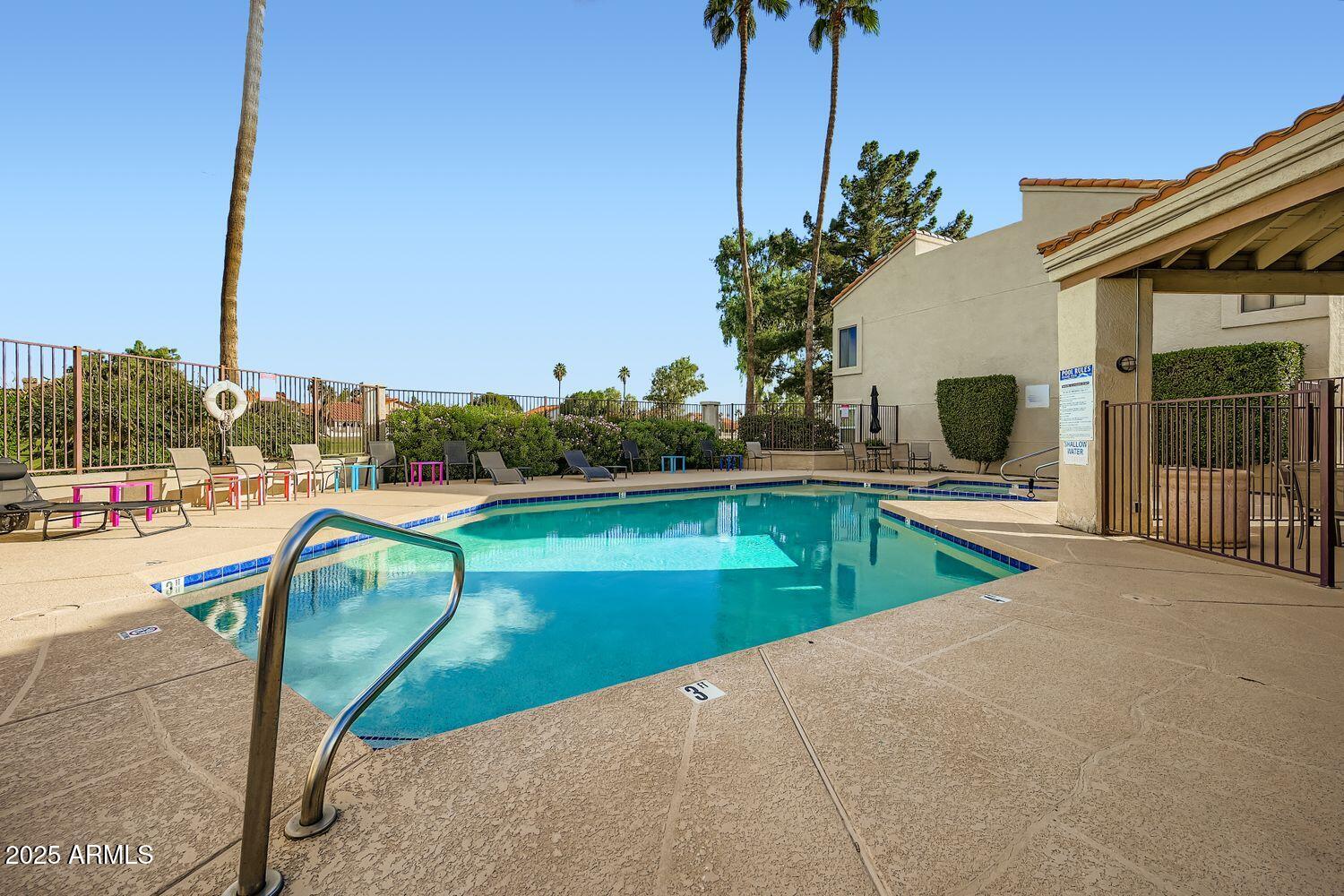 7101 West Beardsley Road, Unit 1403 Glendale, AZ 85308 - Photo 37 of 40 a view of a swimming pool with a lounge chairs