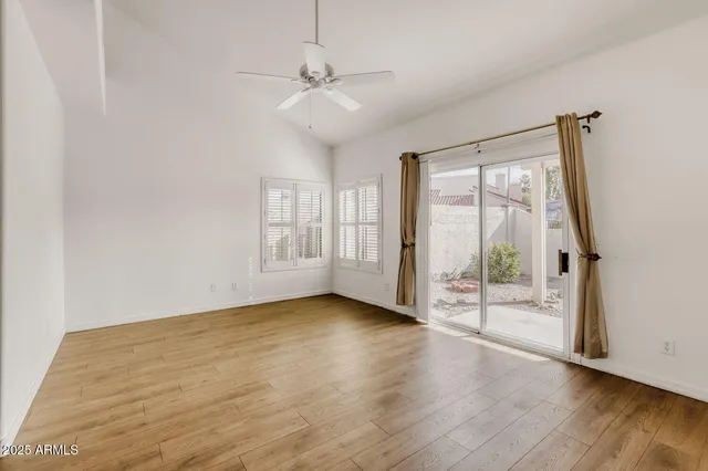 a view of a kitchen with wooden floor and a chandelier