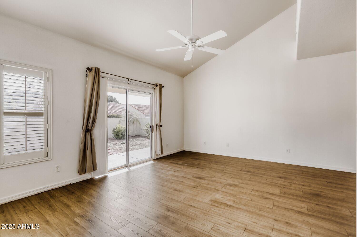 7101 West Beardsley Road, Unit 1403 Glendale, AZ 85308 - Photo 6 of 40 an empty room with wooden floor and windows