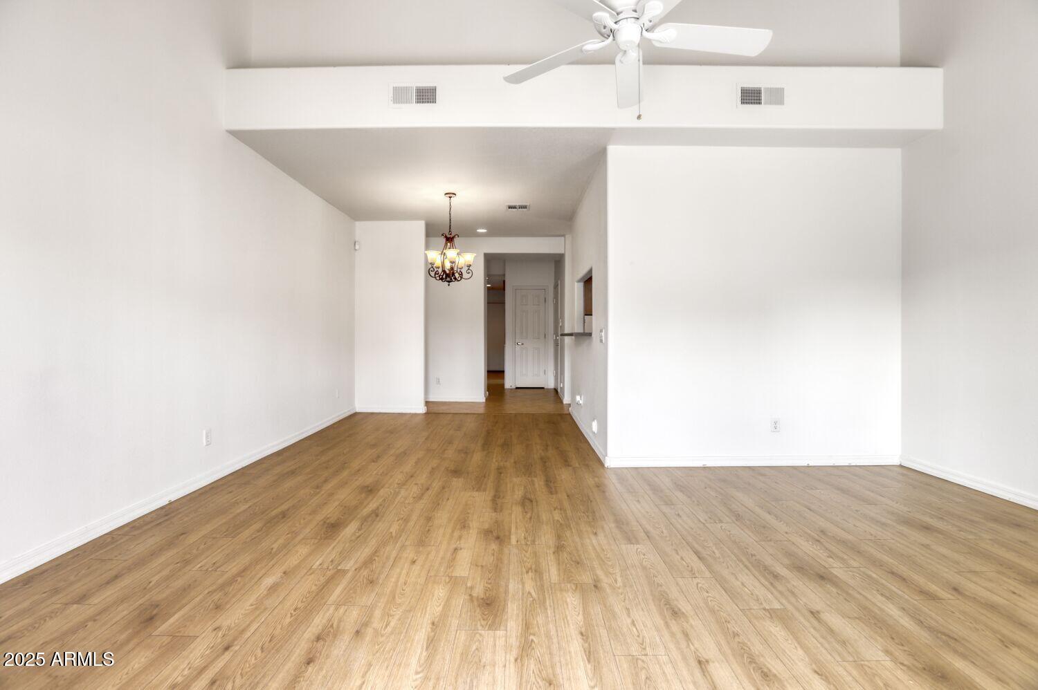 7101 West Beardsley Road, Unit 1403 Glendale, AZ 85308 - Photo 8 of 40 a view of a room with wooden floor and ceiling fan
