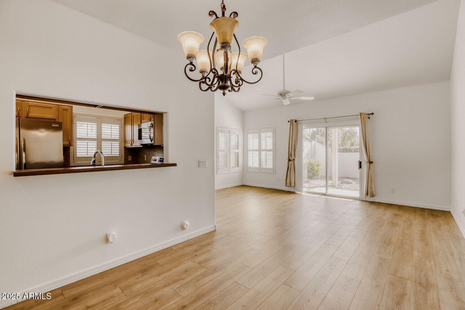 7101 West Beardsley Road, Unit 1403 Glendale, AZ 85308 - Photo 9 of 40 a view of an empty room with a window and wooden floor