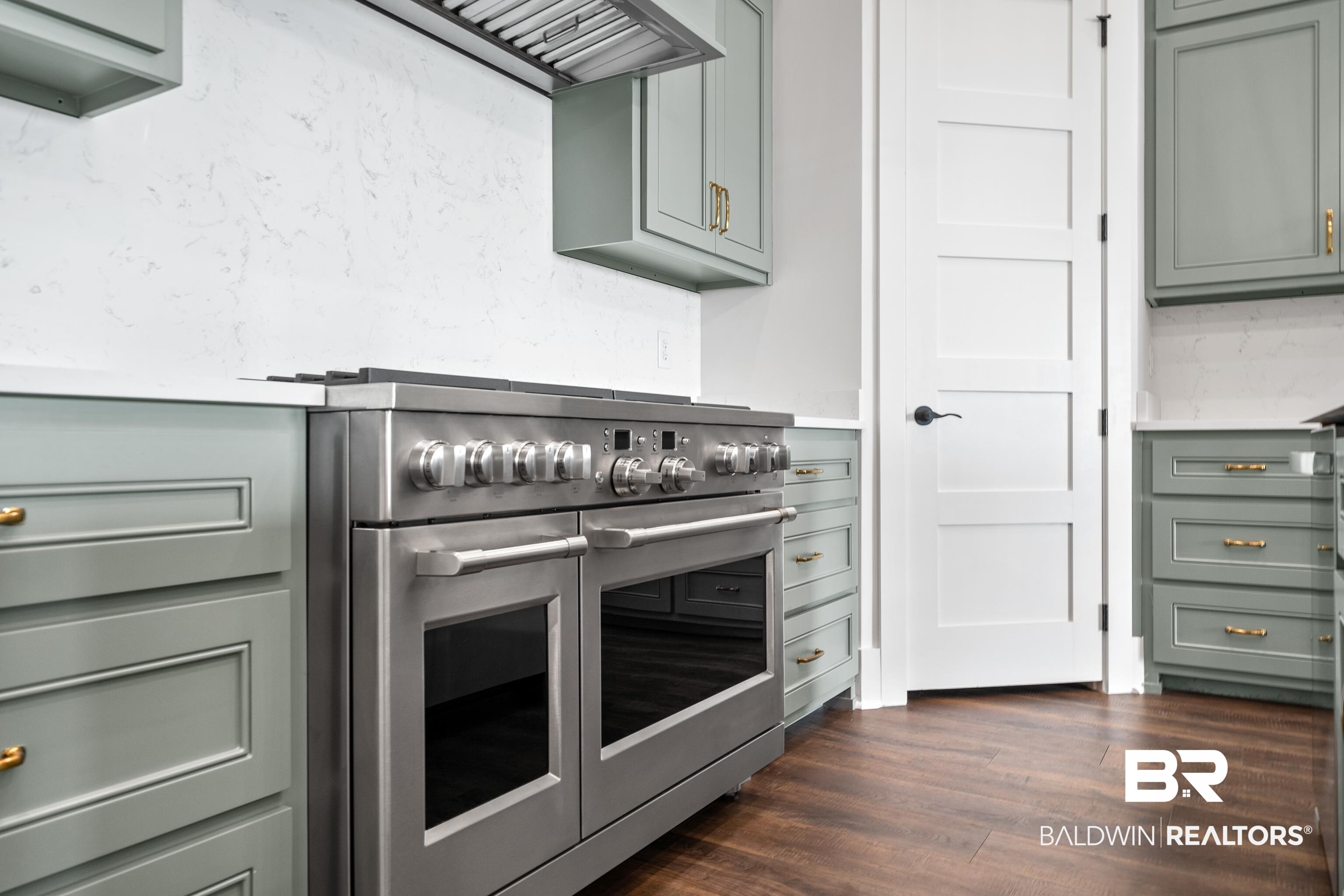 12453 County Road 1 Fairhope, AL 36532 - Photo 6 of 33 Kitchen with backsplash, dark hardwood / wood-style flooring, and range with two ovens