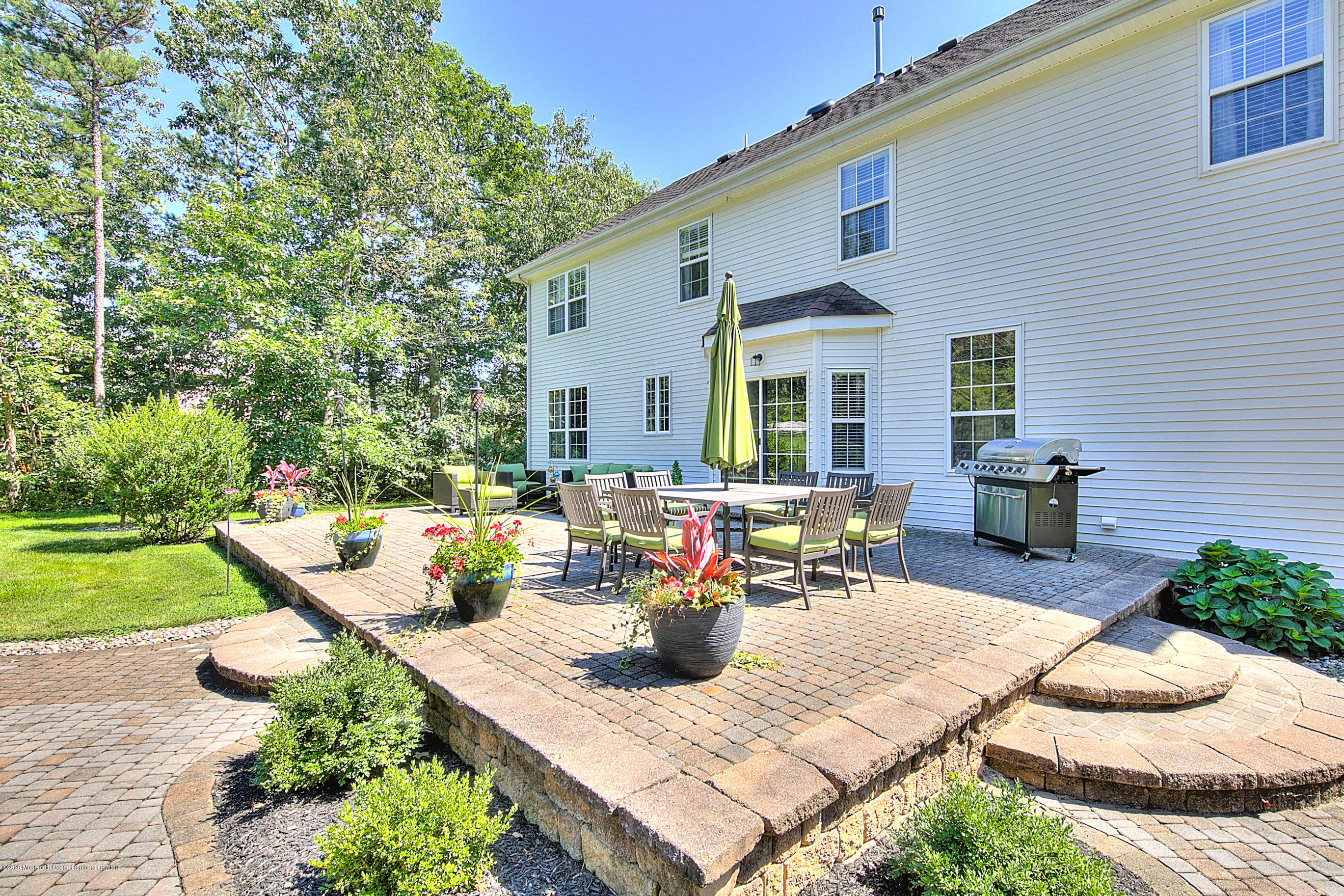 6 Emma Lane Jackson, NJ 08527 - Photo 33 of 39 a view of a patio with table and chairs potted plants and a large tree
