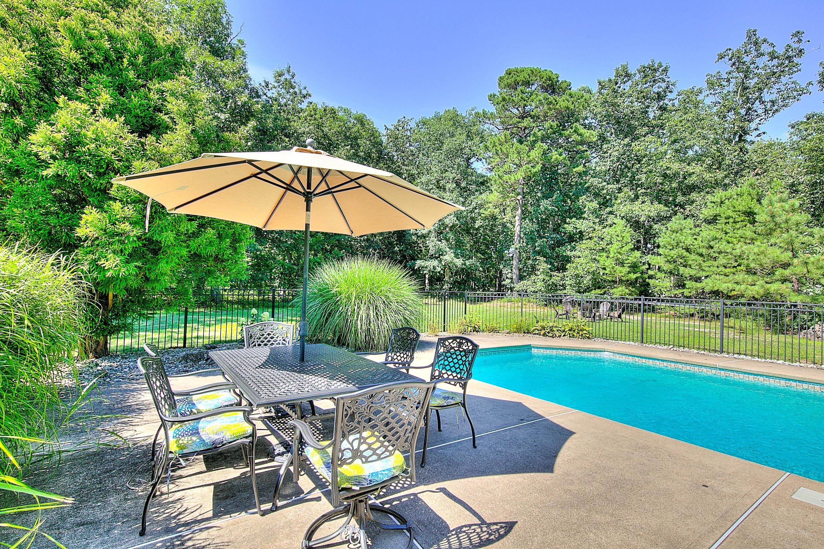 6 Emma Lane Jackson, NJ 08527 - Photo 35 of 39 a view of a swimming pool with an outdoor seating space