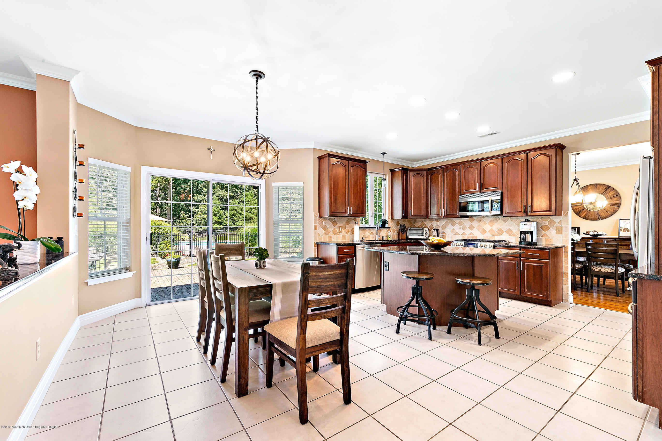 6 Emma Lane Jackson, NJ 08527 - Photo 7 of 39 a dining hall with stainless steel appliances kitchen island granite countertop a table and chairs