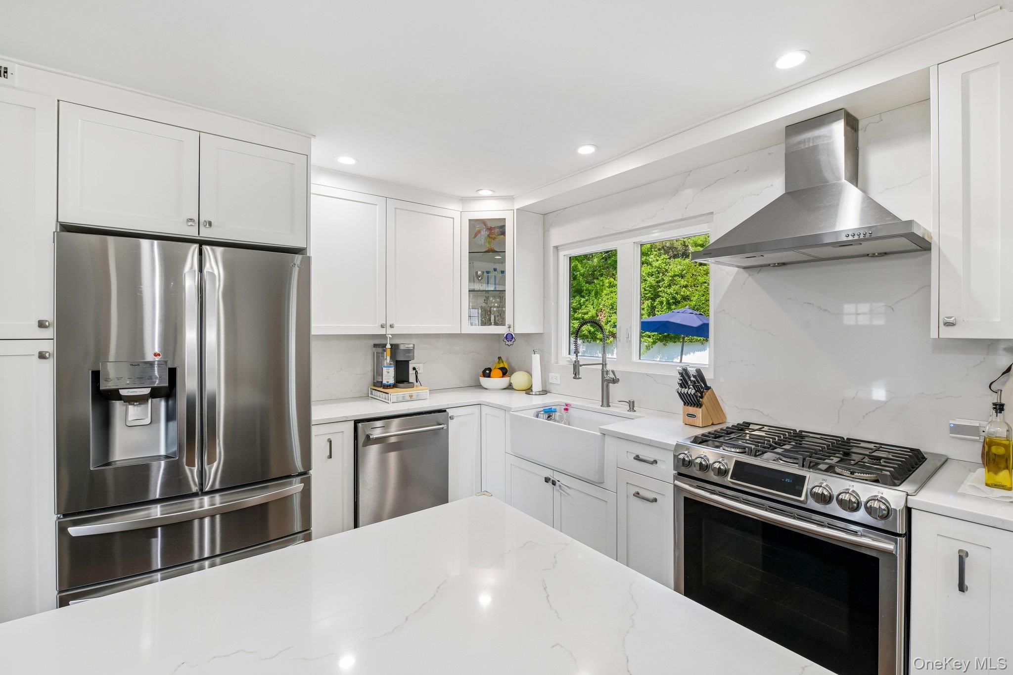 2821 Colonial Avenue Merrick, NY 11566 - Photo 9 of 29 a kitchen with a stove a refrigerator and a sink