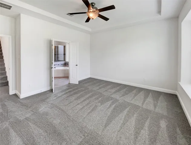 a view of a livingroom with a ceiling fan and window