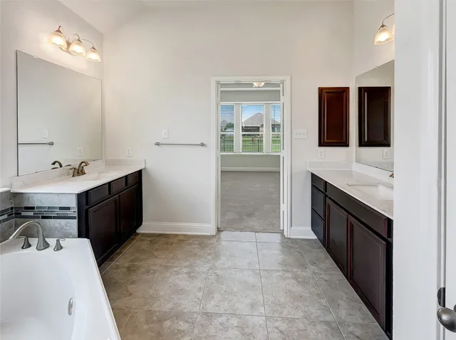 a room with a sink and cabinets