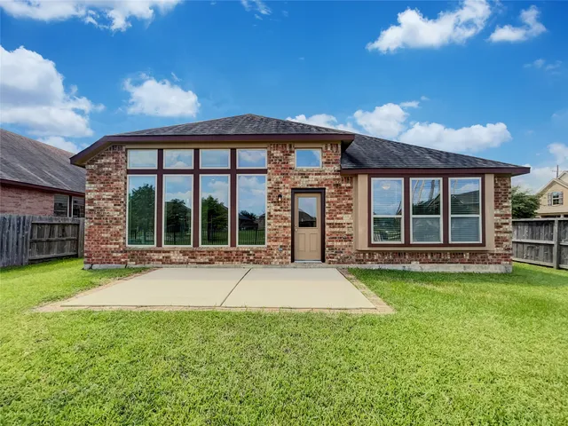 a view of a house with a yard and sitting area