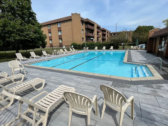 a view of a patio with swimming pool table and chairs