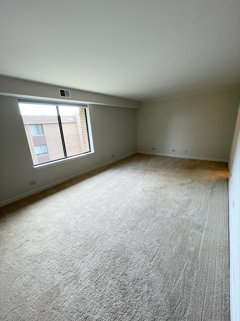 1755 Lake Cook Road, Unit 123 Northbrook, IL 60035 - Photo 6 of 8 an empty room with windows