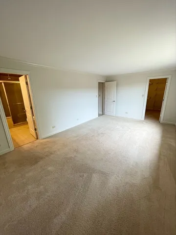 a view of an empty room and a window