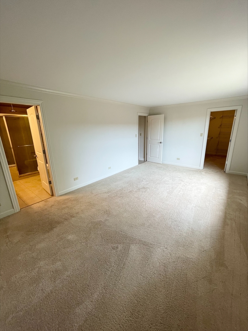 1755 Lake Cook Road, Unit 123 Northbrook, IL 60035 - Photo 7 of 8 a view of an empty room and a window