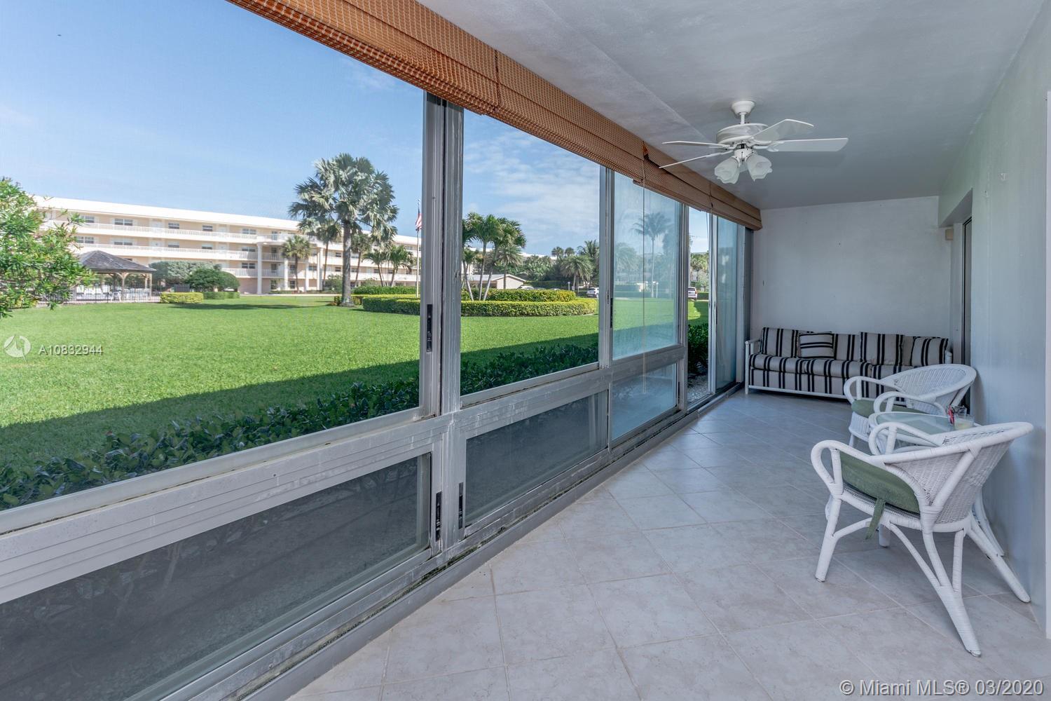 80 Celestial Way, Unit 108 Juno Beach, FL 33408 - Photo 12 of 34 Glass enclosed porch with accordion shutters, tile floors overlooking the manicured grounds