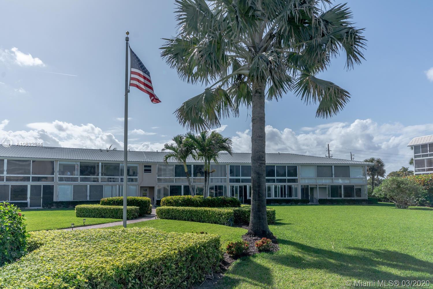 80 Celestial Way, Unit 108 Juno Beach, FL 33408 - Photo 18 of 34 Flagpole in between ocean and lakefront buildings with walking paths and manicured lawns