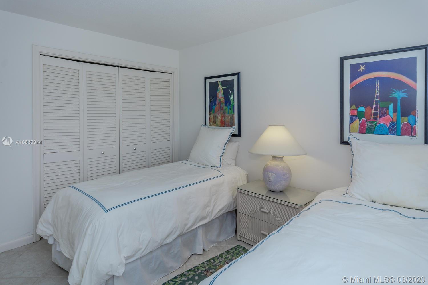 80 Celestial Way, Unit 108 Juno Beach, FL 33408 - Photo 19 of 34 Guest bedroom. Twin beds and view of the lake