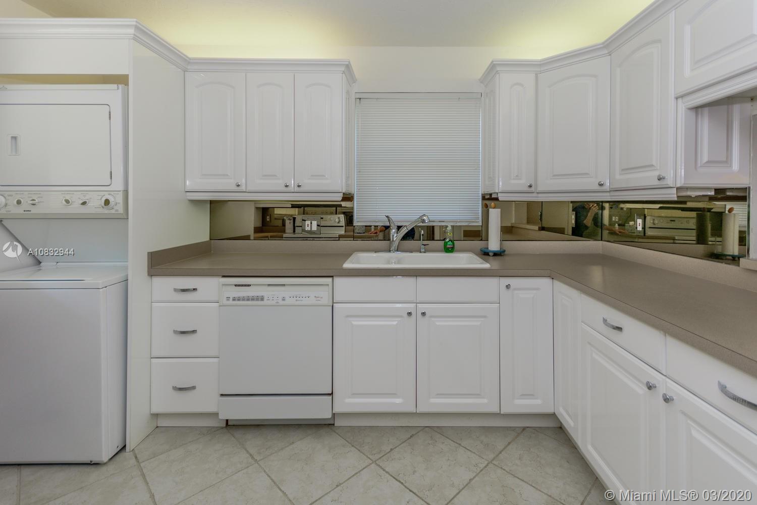 80 Celestial Way, Unit 108 Juno Beach, FL 33408 - Photo 22 of 34 Kitchen with window overlooking private patio and table and chairs to the north and Pelican Lake to the west.