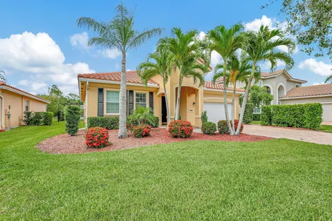 a view of a house with a backyard and porch