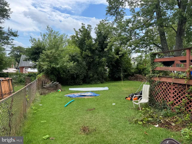 a view of a wooden fence and trees