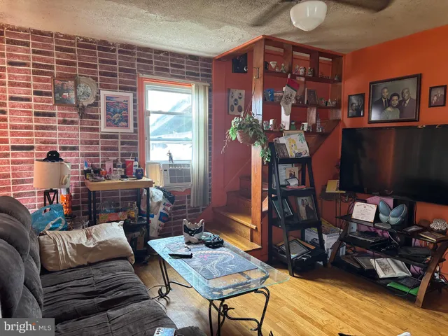 a living room with furniture a dining table and a potted plant