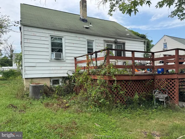 a view of a chair and table in backyard of the house