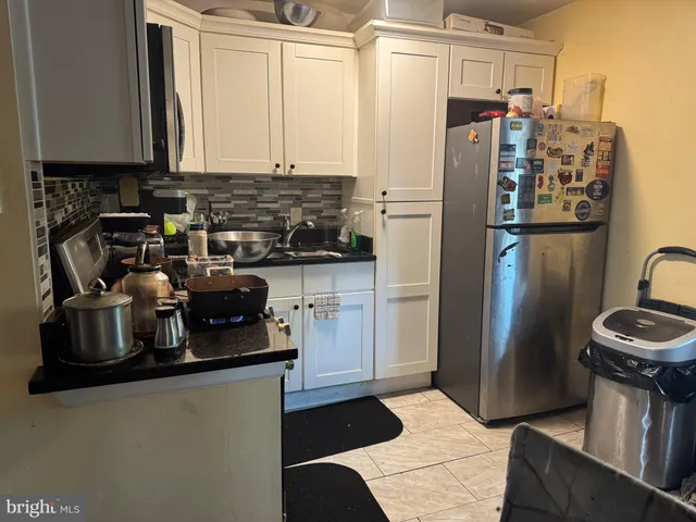 a kitchen with a refrigerator and a sink