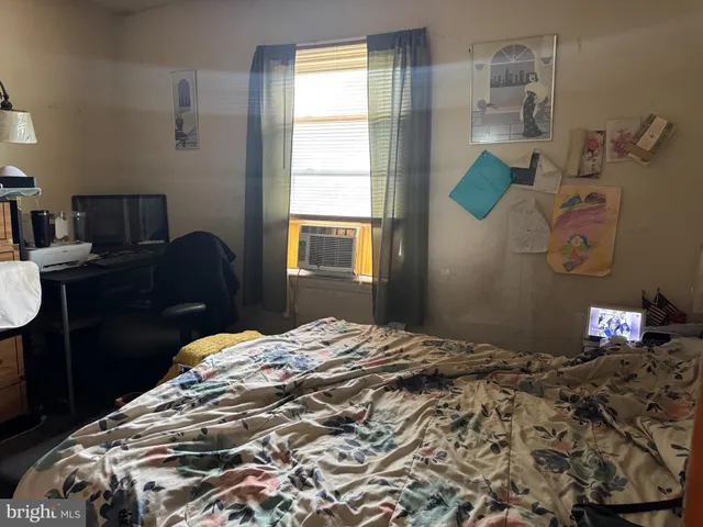 a bedroom with a bed and a window