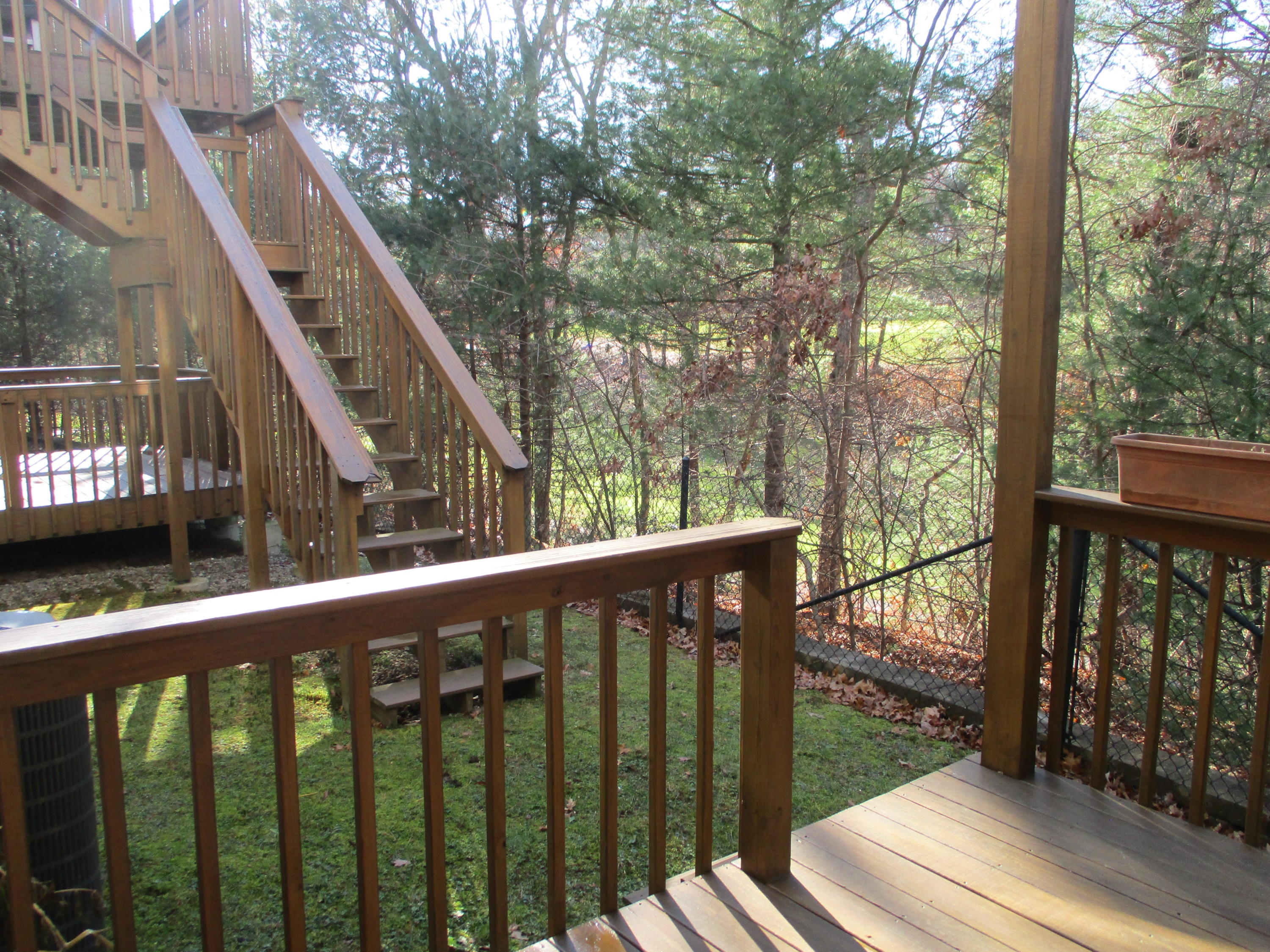 13 North Ridge Road, Unit 440 Mashpee, MA 02649 - Photo 12 of 30 a view of a wooden deck next to a yard