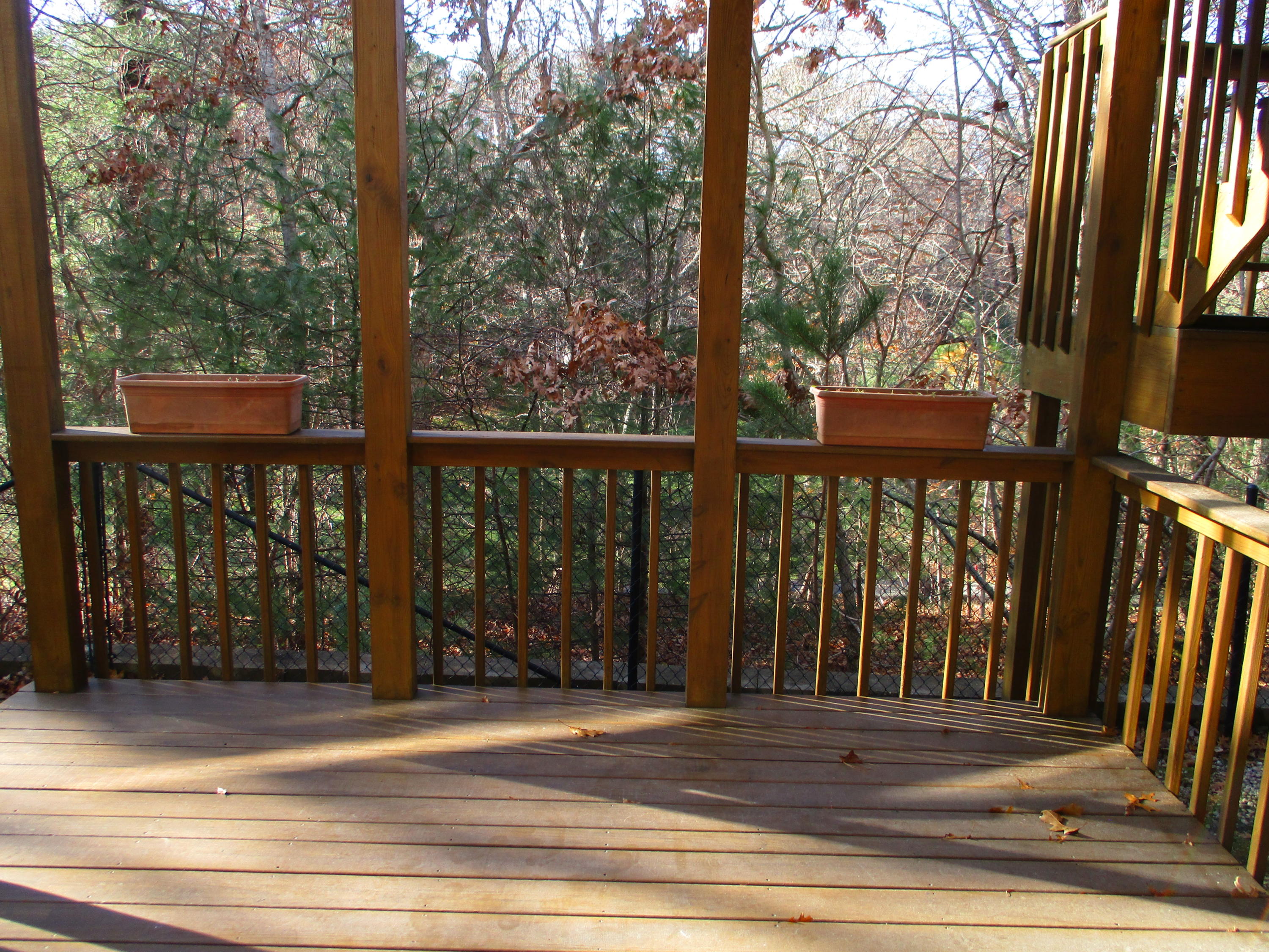 13 North Ridge Road, Unit 440 Mashpee, MA 02649 - Photo 15 of 30 a view of a house with a floor to ceiling window and wooden fence