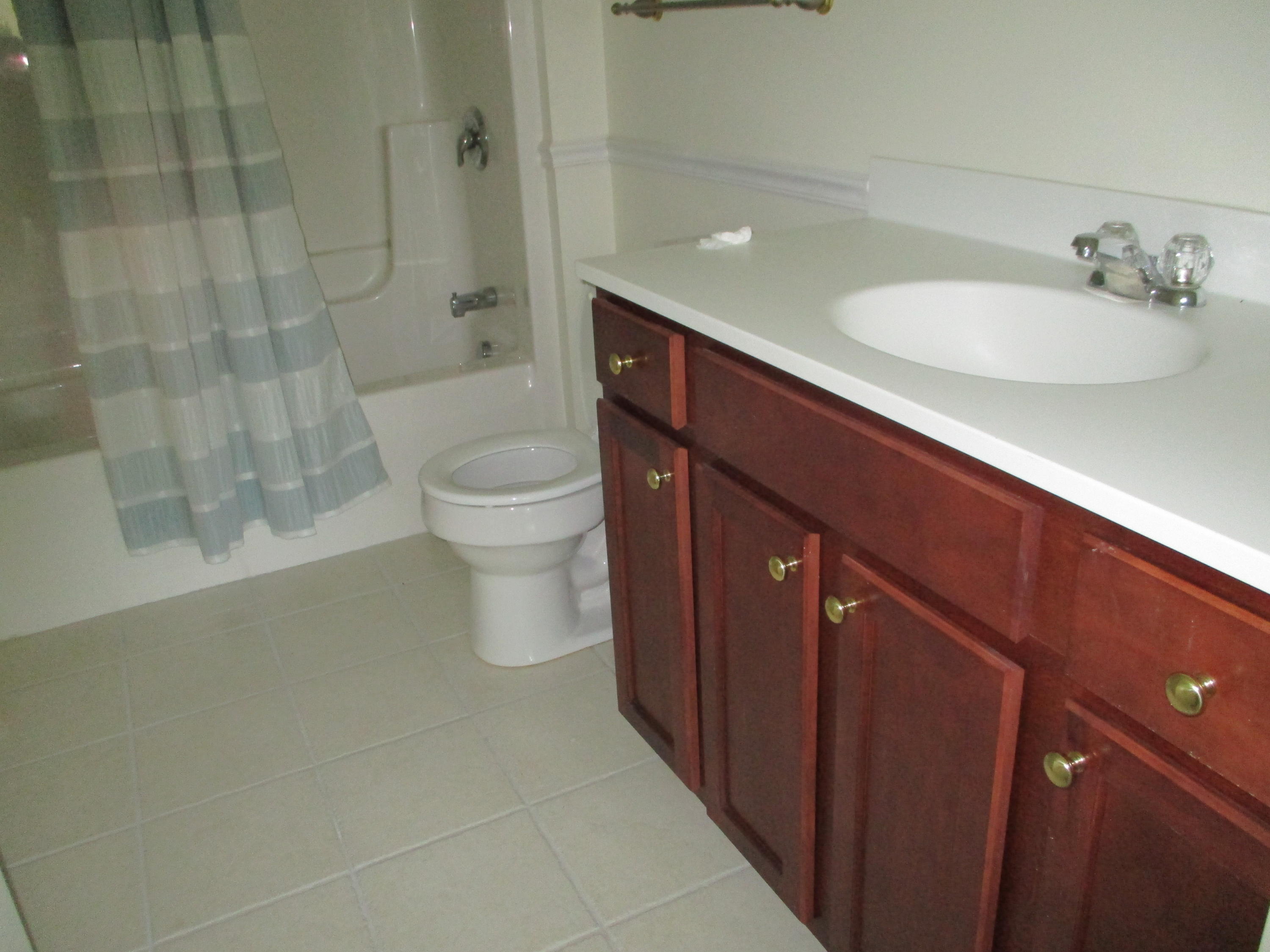 13 North Ridge Road, Unit 440 Mashpee, MA 02649 - Photo 26 of 30 a bathroom with a sink a toilet and shower