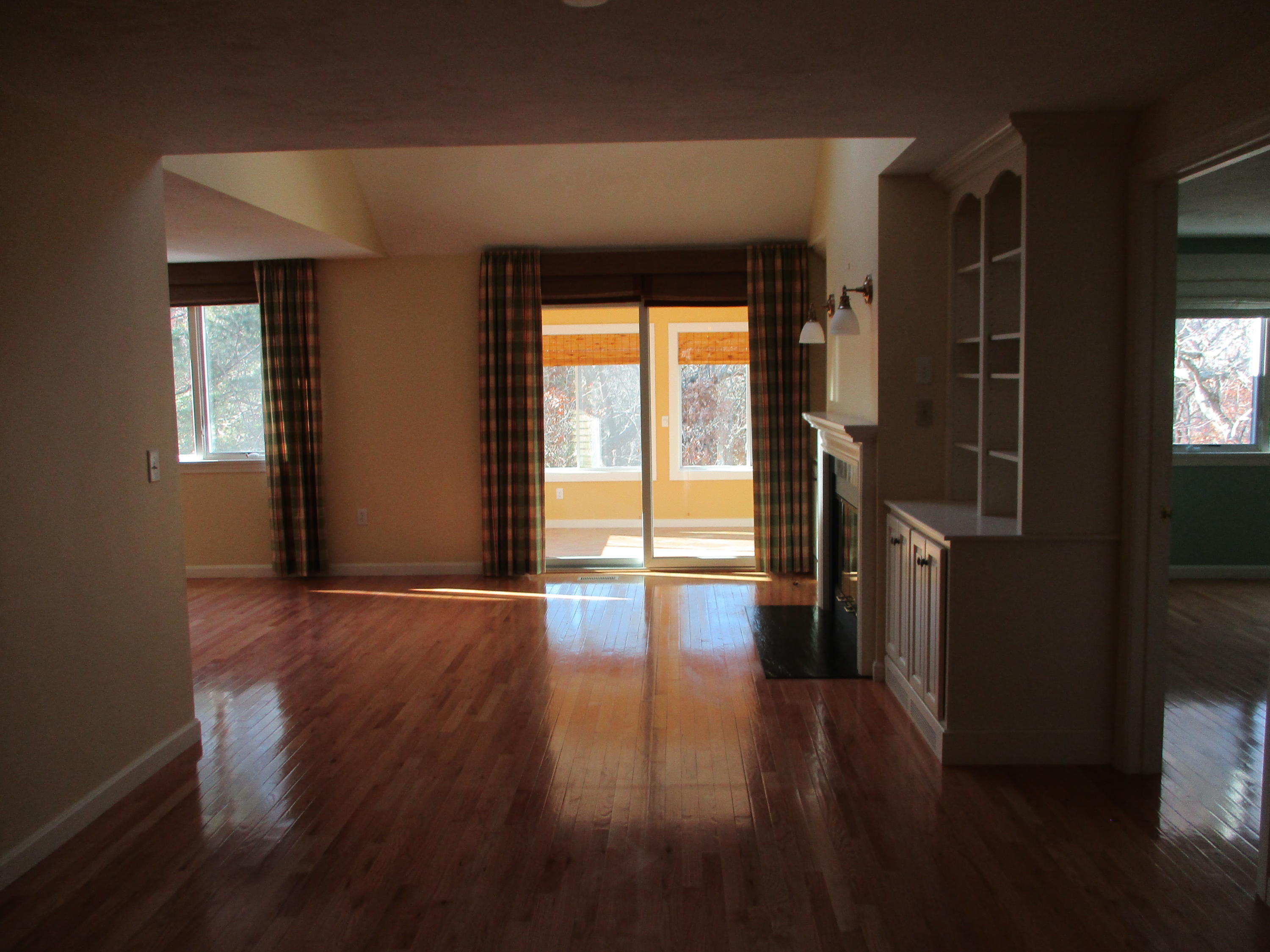13 North Ridge Road, Unit 440 Mashpee, MA 02649 - Photo 4 of 30 a view of empty room with wooden floor and fan
