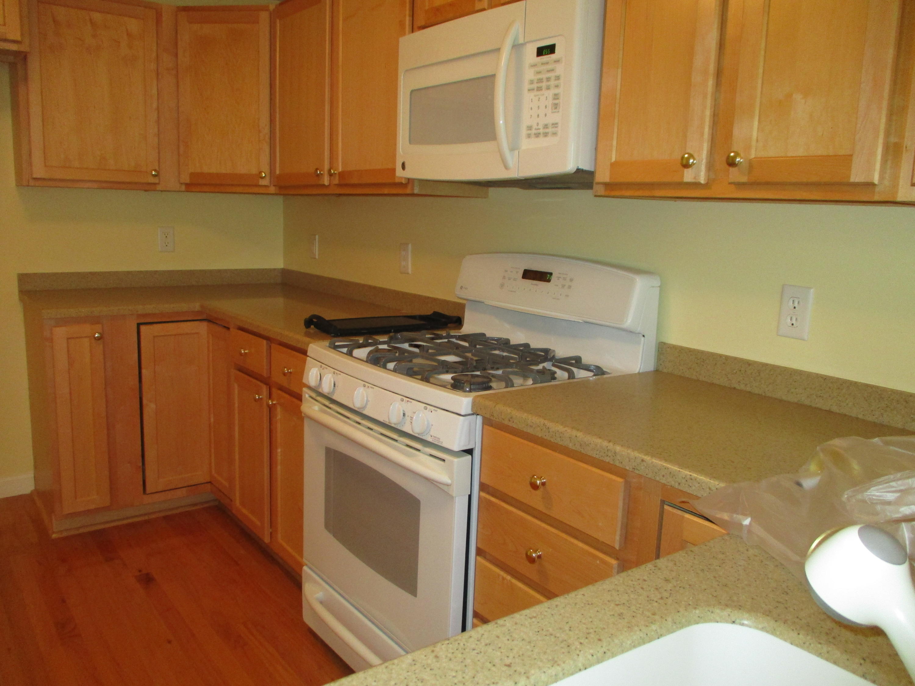 13 North Ridge Road, Unit 440 Mashpee, MA 02649 - Photo 5 of 30 a kitchen with granite countertop a sink cabinets and stainless steel appliances