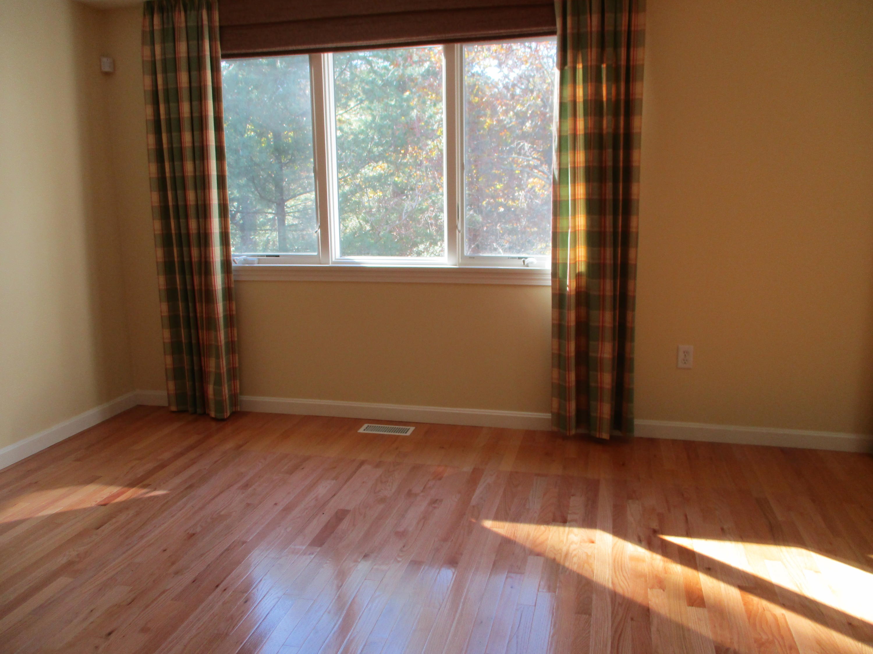 13 North Ridge Road, Unit 440 Mashpee, MA 02649 - Photo 6 of 30 an empty room with wooden floor and windows