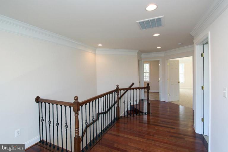 8141 Stacey Road Alexandria, VA 22308 - Photo 22 of 30 a view of a hallway with wooden floor