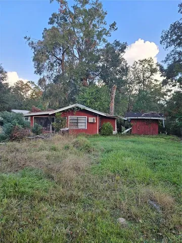 a view of a house with yard and a garden