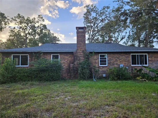 a front view of a house with a green gate