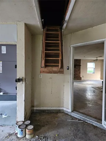 a front view of house with yard and trees around