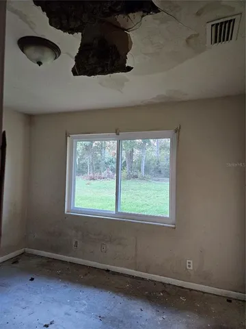 a view of an empty room with a fireplace