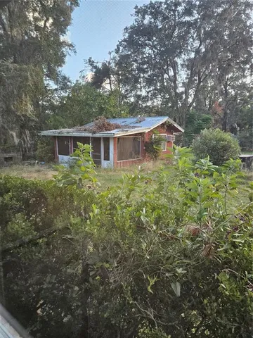 a bathroom with a toilet a window and a shower