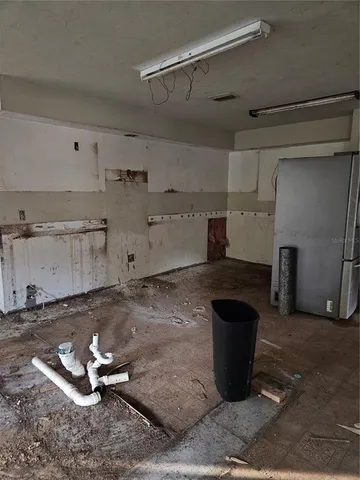 a kitchen with a stove and a refrigerator