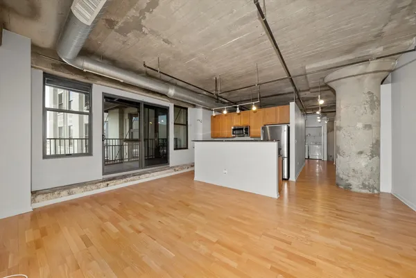 a view of a room with wooden floor and a window