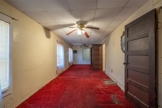 a room with a dresser next to a window