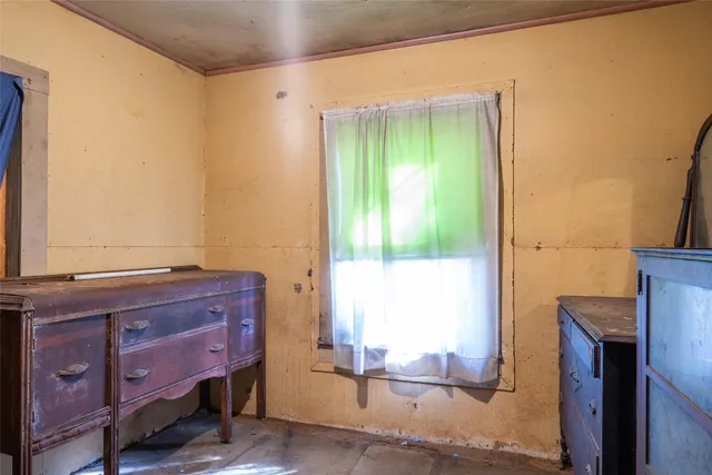 a room with pool table and windows