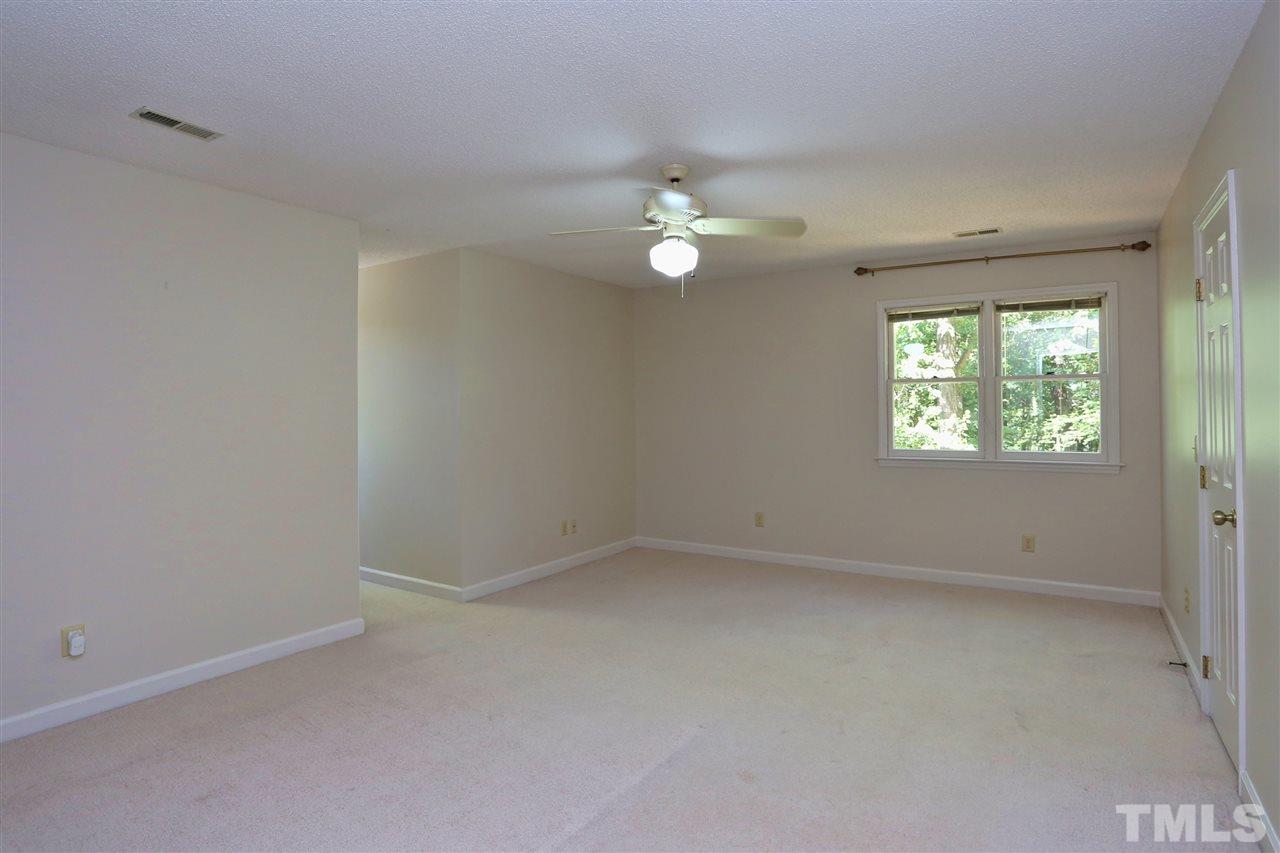 1312 Slatestone Court Raleigh, NC 27615 - Photo 22 of 29 an empty room with windows and fan