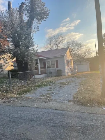 a view of house with backyard