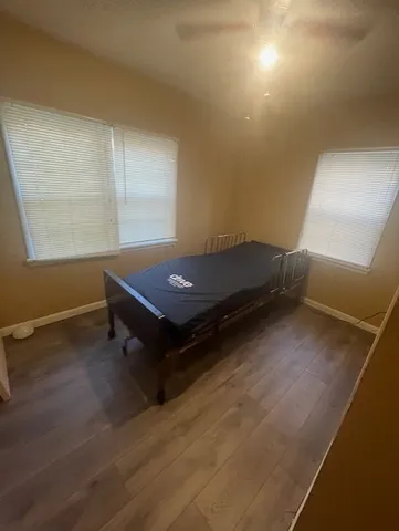a room with pool table and windows