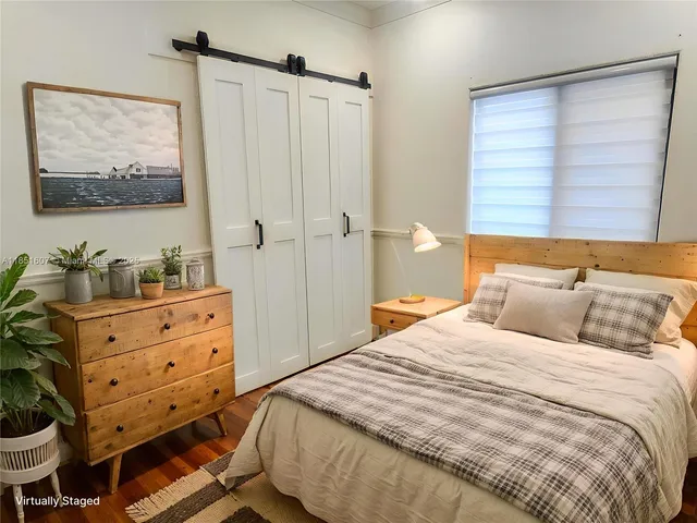 a bedroom with a bed and a dresser in it